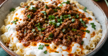 Turkish Pasta Recipe final dish with small tube pasta, creamy garlic yogurt, spiced ground beef, paprika butter sauce, and fresh parsley