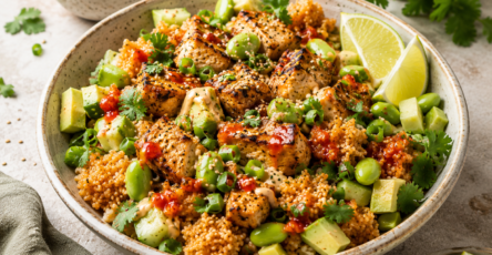 Crispy Rice Chicken Bowl with crispy rice, grilled chicken, avocado, edamame, cucumber, lime, herbs, and creamy sauce